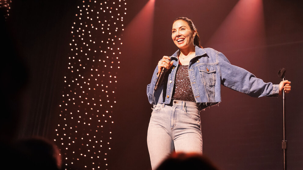 Whitney Cummings performing on tour